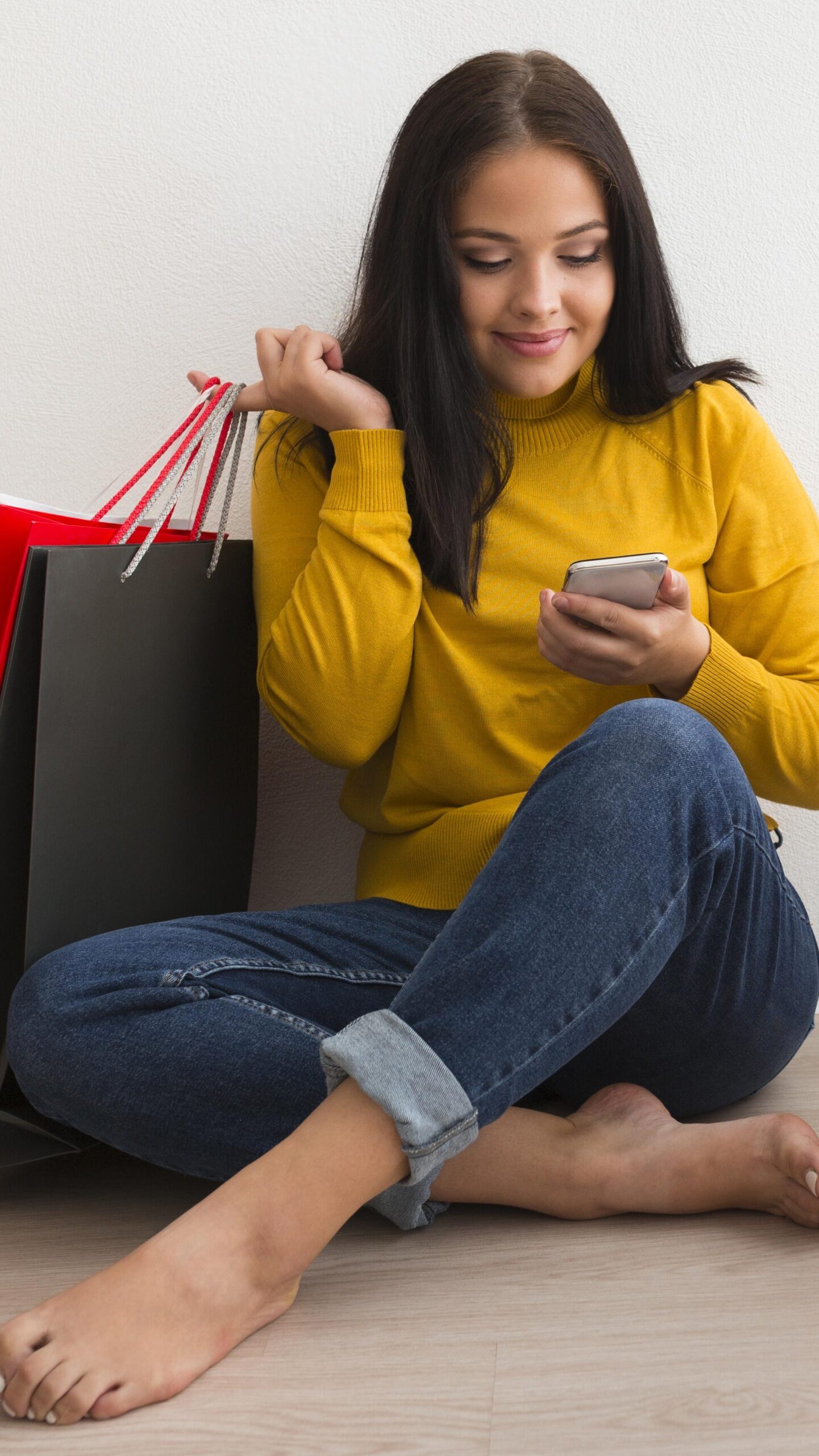 long-shot-woman-sitting-shopping-bags